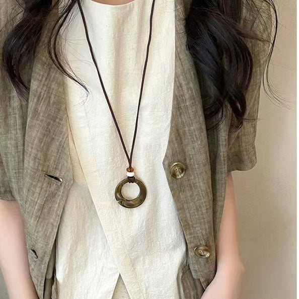 Long black rope necklace with ring pendant