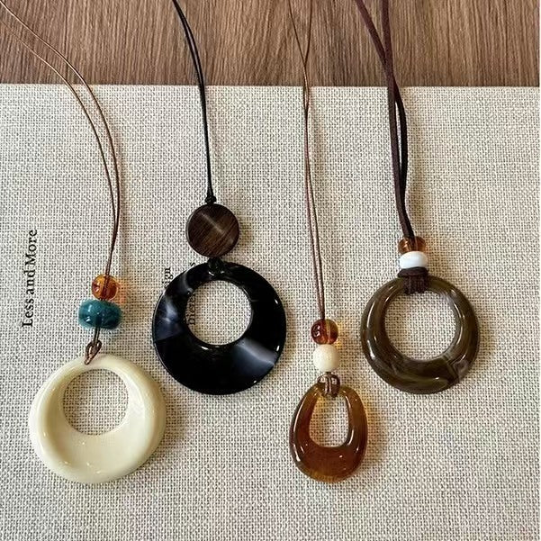Long black rope necklace with ring pendant