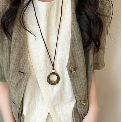 Long black rope necklace with ring pendant